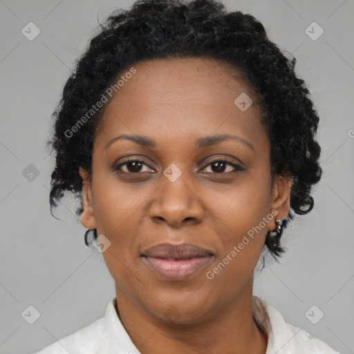 Joyful black adult female with short  brown hair and brown eyes