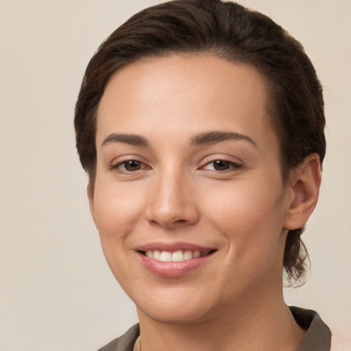 Joyful white young-adult female with short  brown hair and brown eyes