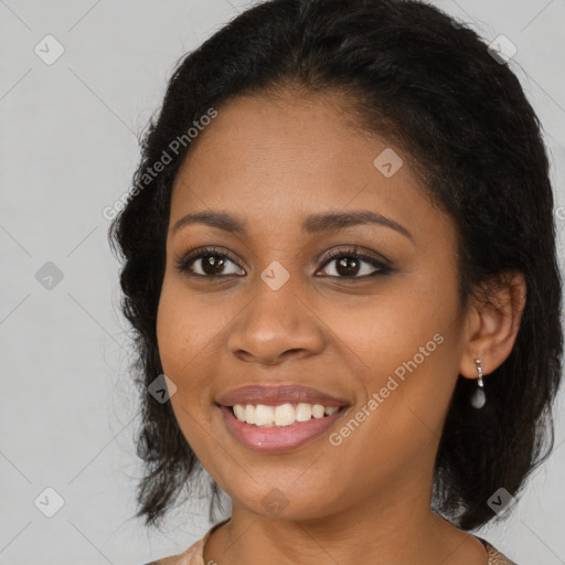 Joyful black young-adult female with long  brown hair and brown eyes