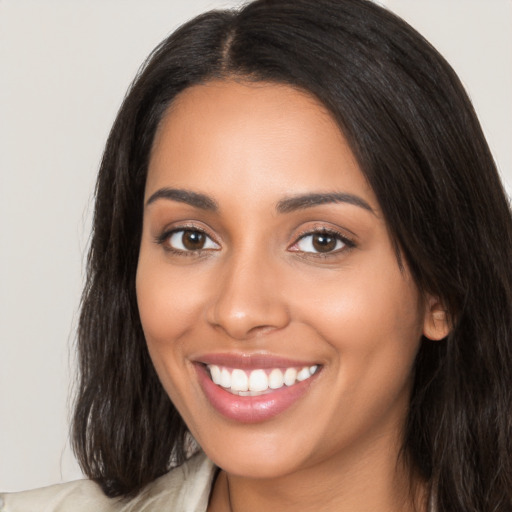 Joyful latino young-adult female with long  brown hair and brown eyes