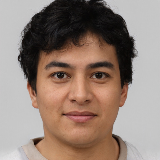 Joyful latino young-adult male with short  brown hair and brown eyes