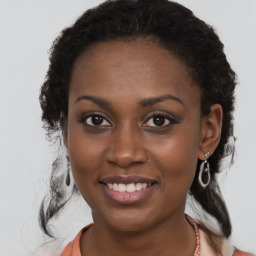 Joyful black young-adult female with medium  brown hair and brown eyes