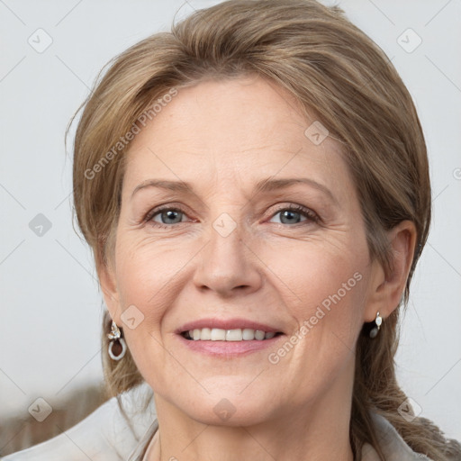 Joyful white adult female with medium  brown hair and grey eyes