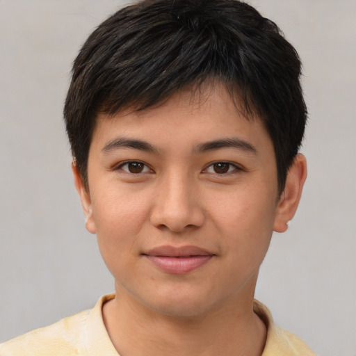 Joyful asian young-adult male with short  brown hair and brown eyes