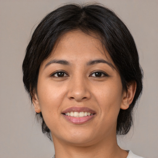 Joyful asian young-adult female with medium  brown hair and brown eyes