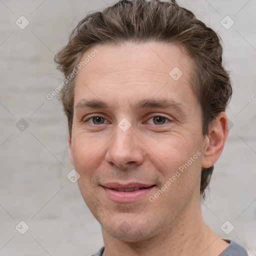 Joyful white adult male with short  brown hair and grey eyes