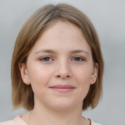 Joyful white child female with medium  brown hair and grey eyes