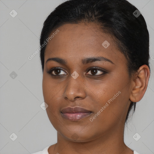 Joyful black young-adult female with short  black hair and brown eyes