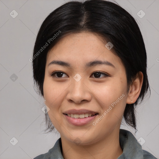 Joyful asian young-adult female with medium  black hair and brown eyes