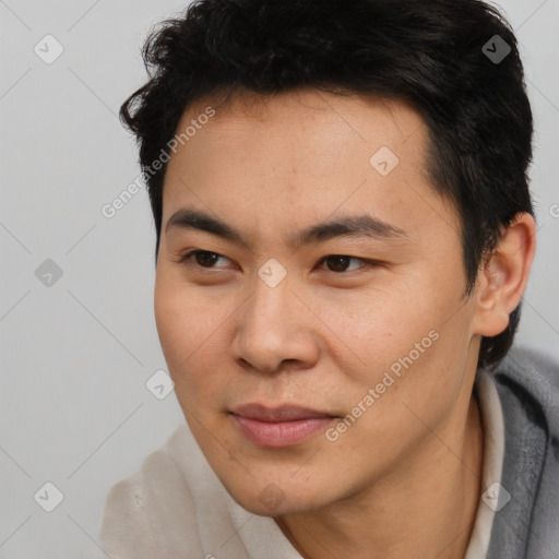 Joyful asian young-adult male with short  brown hair and brown eyes