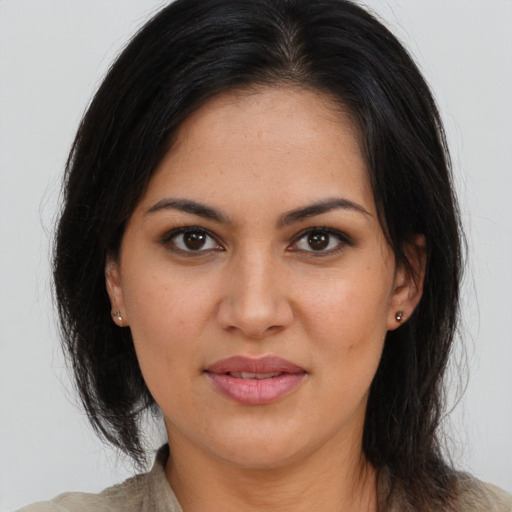 Joyful latino young-adult female with long  brown hair and brown eyes