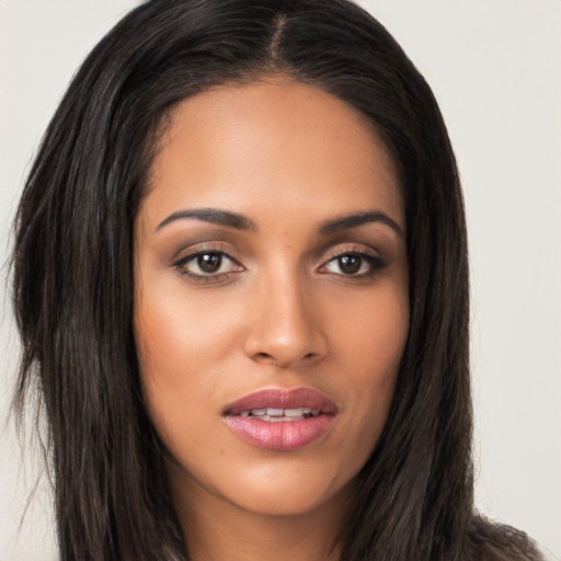 Joyful latino young-adult female with long  brown hair and brown eyes