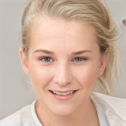 Joyful white young-adult female with medium  brown hair and blue eyes