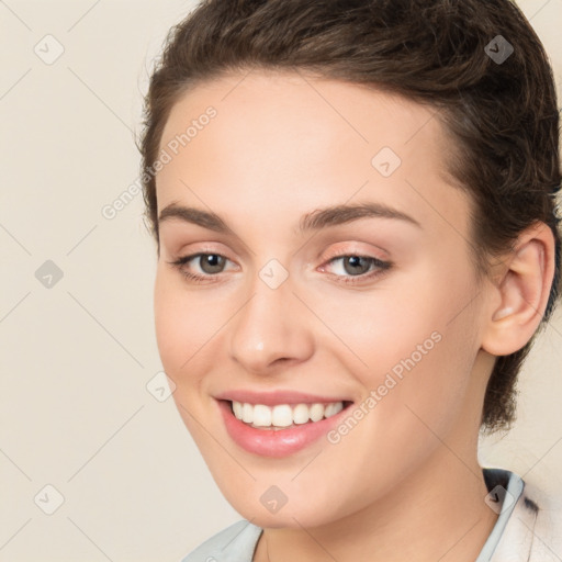 Joyful white young-adult female with medium  brown hair and green eyes