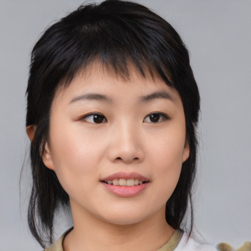 Joyful asian young-adult female with medium  black hair and brown eyes