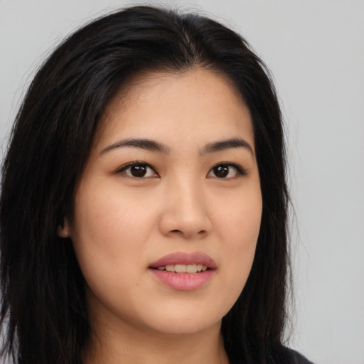 Joyful asian young-adult female with long  brown hair and brown eyes