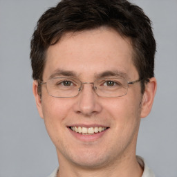 Joyful white adult male with short  brown hair and brown eyes