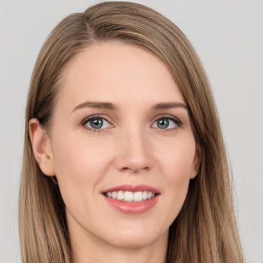 Joyful white young-adult female with long  brown hair and grey eyes