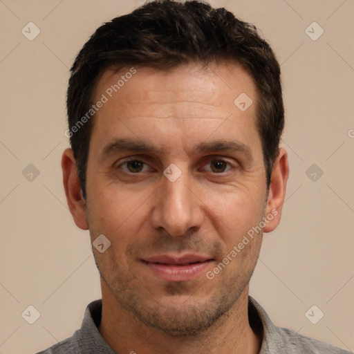 Joyful white adult male with short  brown hair and brown eyes