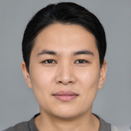 Joyful asian young-adult male with short  black hair and brown eyes