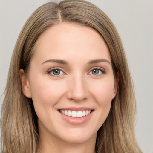 Joyful white young-adult female with long  brown hair and grey eyes