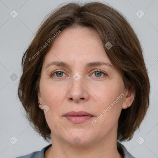 Joyful white adult female with medium  brown hair and grey eyes