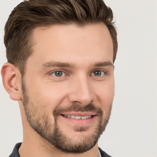 Joyful white young-adult male with short  brown hair and grey eyes