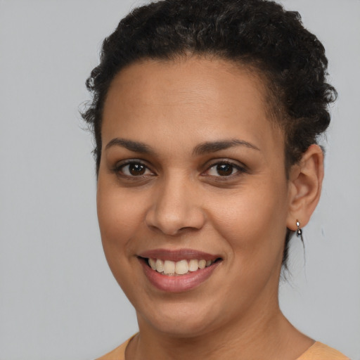 Joyful latino young-adult female with short  brown hair and brown eyes