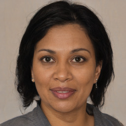 Joyful black adult female with medium  brown hair and brown eyes