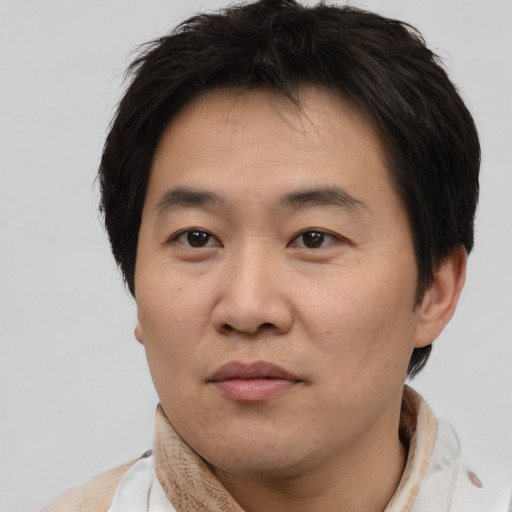 Neutral asian adult male with short  brown hair and brown eyes