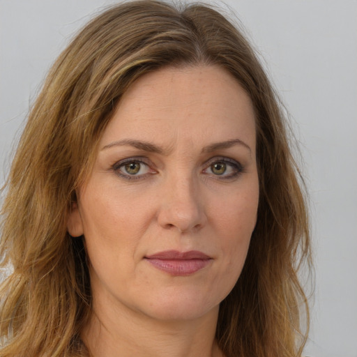 Joyful white adult female with long  brown hair and brown eyes