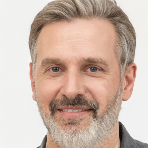 Joyful white middle-aged male with short  gray hair and brown eyes