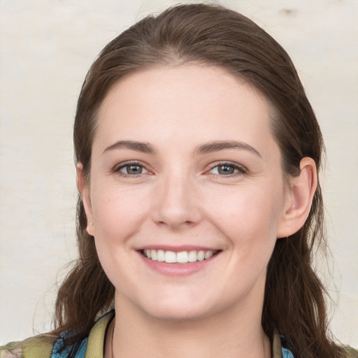 Joyful white young-adult female with medium  brown hair and grey eyes