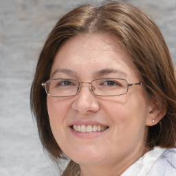 Joyful white adult female with medium  brown hair and blue eyes