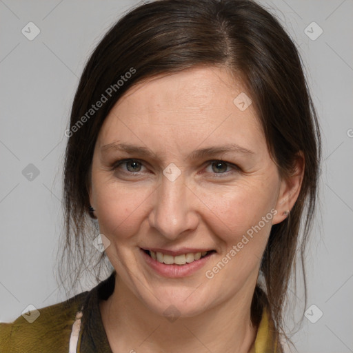 Joyful white adult female with medium  brown hair and brown eyes