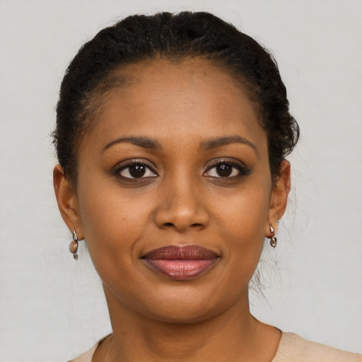 Joyful black young-adult female with short  brown hair and brown eyes