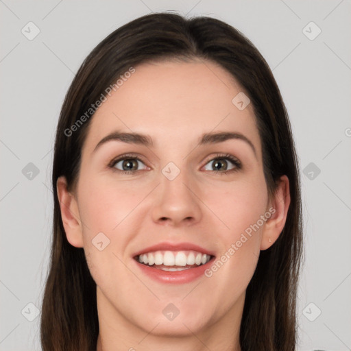 Joyful white young-adult female with long  brown hair and grey eyes