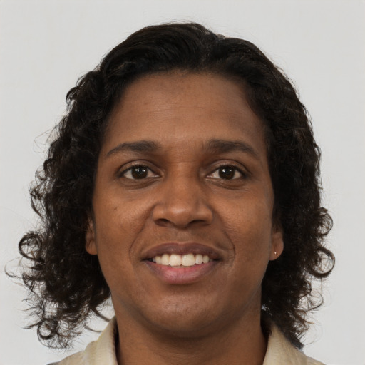Joyful black young-adult female with medium  brown hair and brown eyes