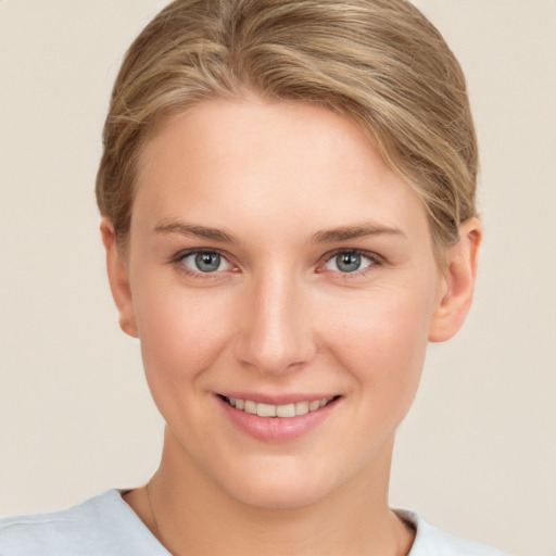 Joyful white young-adult female with short  brown hair and grey eyes