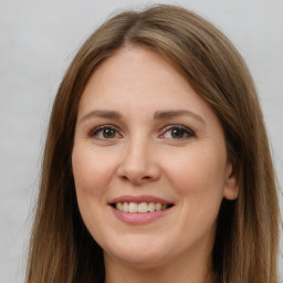 Joyful white young-adult female with long  brown hair and brown eyes