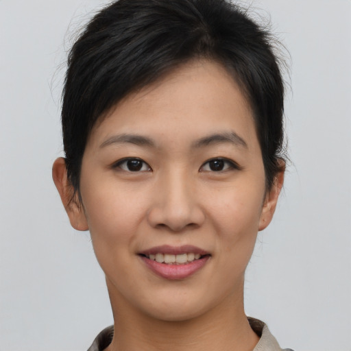 Joyful asian young-adult female with short  brown hair and brown eyes