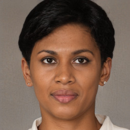Joyful black young-adult female with short  brown hair and brown eyes
