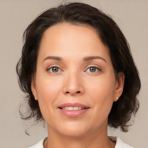 Joyful white adult female with medium  brown hair and brown eyes