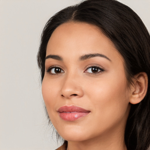 Joyful latino young-adult female with long  black hair and brown eyes