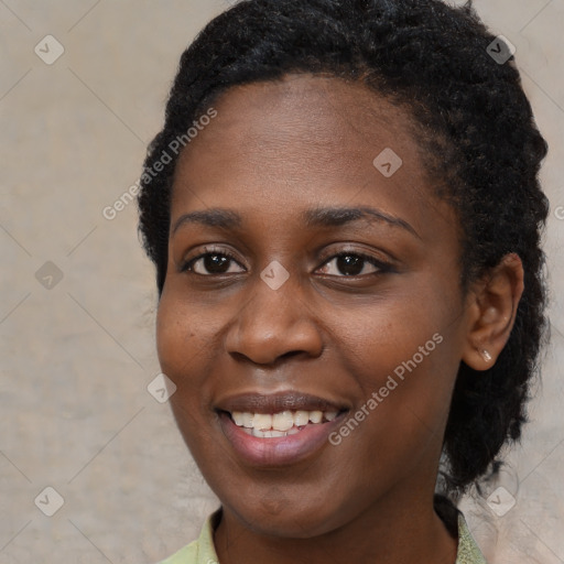 Joyful black young-adult female with short  black hair and brown eyes