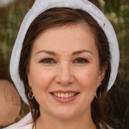 Joyful white adult female with medium  brown hair and brown eyes