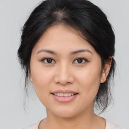 Joyful asian young-adult female with medium  brown hair and brown eyes