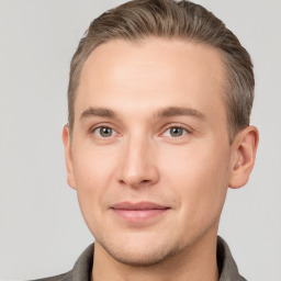 Joyful white young-adult male with short  brown hair and grey eyes