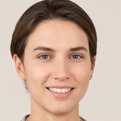 Joyful white young-adult female with short  brown hair and brown eyes