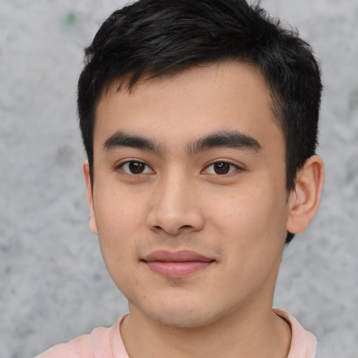 Joyful asian young-adult male with short  black hair and brown eyes